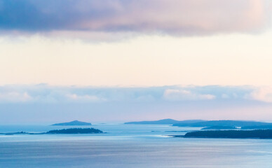 Fototapeta premium Serene White Sea coastal landscape of the White Sea shore at dusk with islands and gentle waves in a tranquil ocean setting.