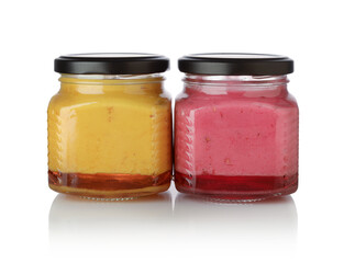 Berry jam in glass jars isolated.