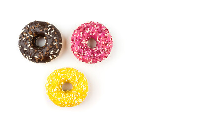 Three donuts with glaze isolated on white top view, copy space, place for text, banner.