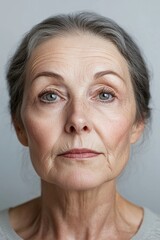 A close-up shot of a woman wearing a gray shirt.