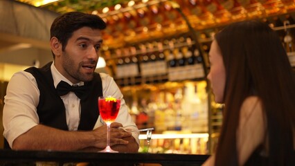 Bartender serving mixed vodka Cosmopolitan red cocktail decorated with flower for beautiful guest at luxurious counter bar perfect vibrant color presentation highlight atmosphere nightclub. Vinosity.