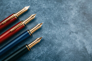 Branded highend fountain pens with intricate details, placed on an elegant marble table, premium corporate gifts concept