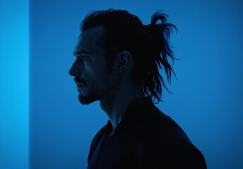 Silhouette of Man with Ponytail in Blue Lighting