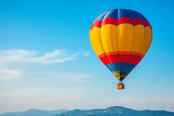 Fototapeta premium A vibrant hot air balloon soars majestically over Grants Pass, Oregon, on a beautiful summer morning, showcasing the lush landscape of rolling hills under clear blue skies.