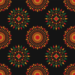 Seamless kwanzaa pattern with circular and star shapes forming a mandala, in green, red, orange and yellow on black background