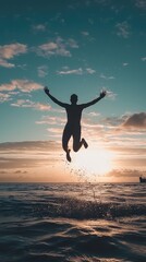 Fototapeta premium A silhouette of a person joyfully jumping into the ocean during a stunning sunset, capturing freedom and adventure.