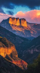 Naklejka premium Breathtaking mountain landscape under vibrant skies, showcasing dramatic rock formations and colorful sunset hues.