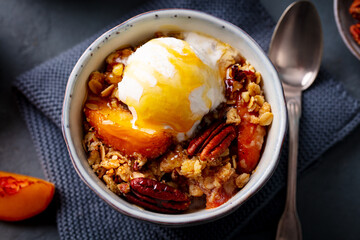 Peach crumble cake with ice cream. Grey background. Top view. Close up.