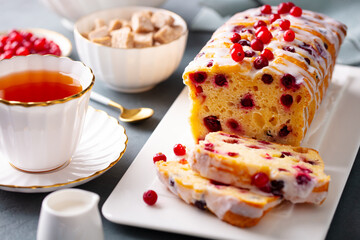 Cranberry cake, loaf bread with cup of tea. Close up.