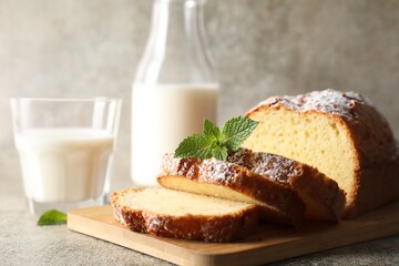 Freshly baked sponge cake on light grey table, closeup