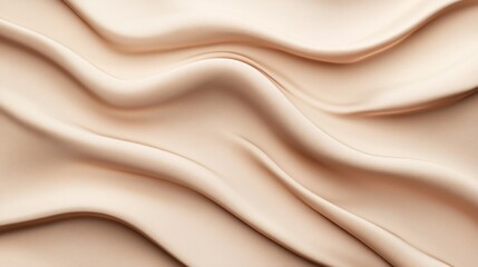 Obraz premium Elegant beige silk fabric creates smooth flowing waves, beautifully showcasing the texture and depth of the material against a neutral background.
