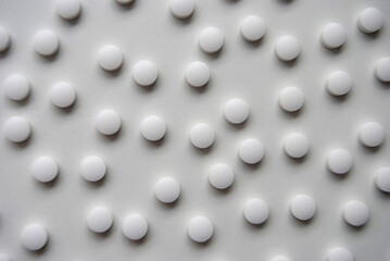 White pills on a white background. White pills close-up. Pills background. Medications and treatment.