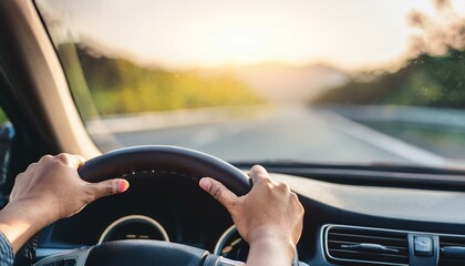hands of car driver on steering wheel