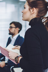 Crew of young professional people spending time for consultancy about information for business startup project, male and female coworkers communicate together in conference room during working process