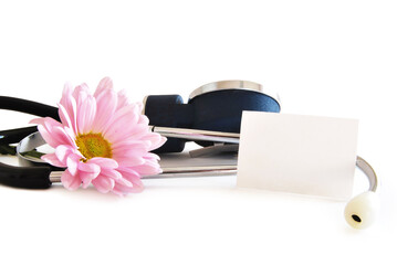 A white clean card next to a stethoscope and a pink flower on white background