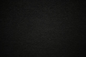 Black paper or cardboard texture as background	