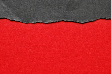 A stripe of a black torn paper above a sheet of red paper for your text or design, Black Friday concept