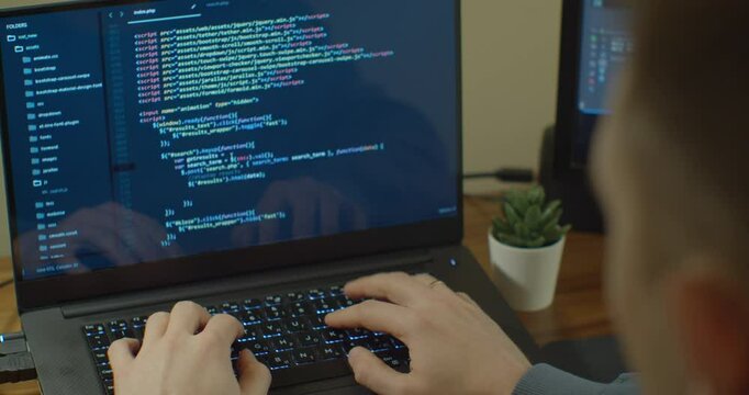 Closeup coding on screen, Man hands coding html and programming on screen Monitors, development web, developer.