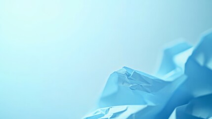 Abstract close-up of crumpled blue paper with soft lighting, creating a serene and minimalistic composition on a light background.