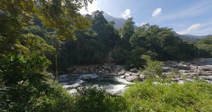 Small waterfall river in jungle. Hard trek to hidden ancient ruins of Tayrona civilization Ciudad Perdida in Colombian jungle. Santa Marta, Sierra Nevada mountains, Colombia wilderness landscape.