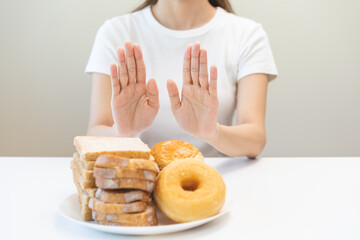 Gluten allergy, asian young woman hand push out, refusing to eat bread and donut or doughnut on...