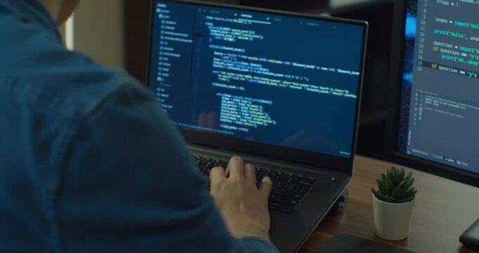Closeup coding on screen, Man hands coding html and programming on two screen Monitors, development web, developer.