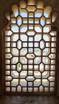City of Udaipur looking through the stone lattice window of the City Palace