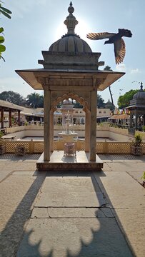 Sunset creating the perfectly symmetrical angle for shadow of a dome shaped fountain structure at Jagamandir Palace, Lake Pichola, Udaipur