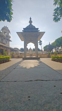 Sunset creating the perfectly symmetrical angle for shadow of a dome shaped fountain structure at Jagamandir Palace, Lake Pichola, Udaipur