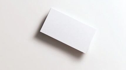 Minimalist photo of a blank white business card on a plain background, perfect for branding, design mockups, and creative projects.