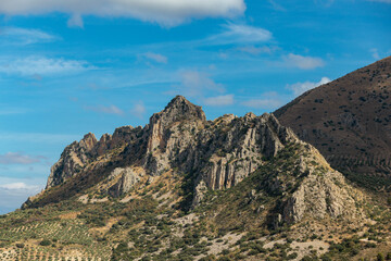 Mountain peaks reaching for the blue sky on a sunny day