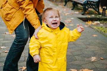 Crying little boy outdoor in the park.