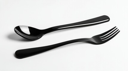 Obraz premium Black takeaway fork and spoon on a white background, emphasizing modern and elegant food delivery cutlery.