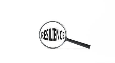 Resilience symbol. Concept word Resilience in beautiful magnifying glass. Beautiful white paper background. Business resilience concept. Copy space.