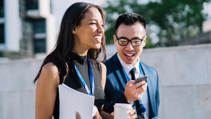 Relaxed cheerful coworkers on street