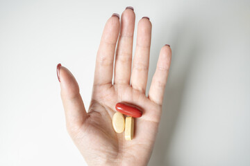 Hand Holding Colorful Pills for Health and Wellness Concept