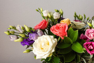 Celebrate special occasions with a colorful summer bouquet featuring fresh roses, eucalyptus, and eustoma blooms, creating an elegant and fragrant floral arrangement
