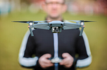 Man with flying drone. Concept of cybernetics and robotics