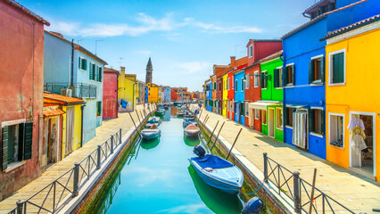 Burano island canal, colorful houses and boats in the Venice lagoon. Italy