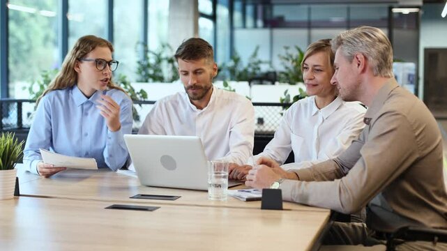 startup business team on meeting in modern bright office interior brainstorming, working on laptop and tablet computer.