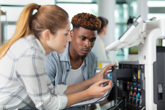 technician working on photocopier changing toner