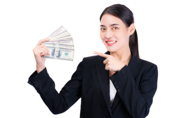 Confident businesswoman in formal suit holding a fan of dollar bills, smiling and pointing to the cash. The image conveys success, financial achievement, and professional confidence.