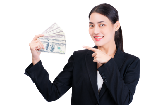 Confident businesswoman in formal suit holding a fan of dollar bills, smiling and pointing to the cash. The image conveys success, financial achievement, and professional confidence.