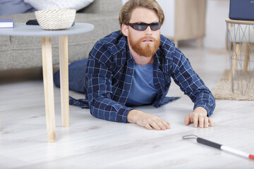 young blind man fell on the floor