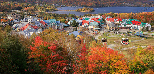 Lake and Mont Tremblant resort in autumn with cable car on the foreground, Canada