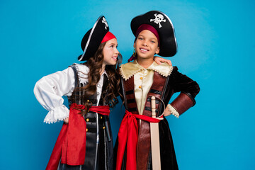 Portrait of two little kids cuddle wear halloween pirate costume isolated on blue color background