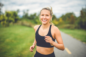 Front view of a happy runner teen doing jogging