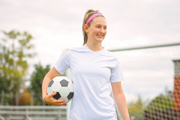 Naklejka premium motivation soccer player with a football in a sport uniform wearing in white
