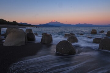 Serene Sunset Over Mount Fuji:  A breathtaking panorama of Mount Fuji silhouetted against a vibrant...