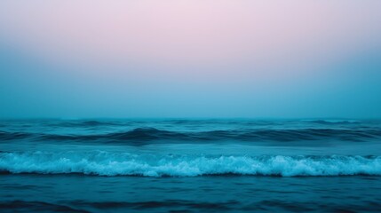 Fototapeta premium A blurred background of ocean waves rolling towards the shore, shot in natural light to create a soft, serene atmosphere.